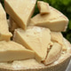 Chunks of Parmesan cheese on a wheel with a blurred natural background Chunks of Parmesan cheese on a wheel with a blurred natural background - PhotoDune Item for Sale