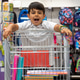 Happy school boy with shopping cart full of supplies for back to school Happy school boy with shopping cart full of supplies for back to school - PhotoDune Item for Sale