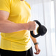 Sporty Man Doing Home Workout With Dumbbells Sporty Man Doing Home Workout With Dumbbells - PhotoDune Item for Sale