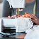 Sewing a Garment on a White Machine in a Workspace Sewing a Garment on a White Machine in a Workspace - PhotoDune Item for Sale
