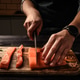 Chief cutting salmon red fish fillet on a cutting board Chief cutting salmon red fish fillet on a cutting board - PhotoDune Item for Sale