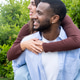 Happy young couple on a piggyback outdoors enjoying an affectionate moment in a green garden Happy young couple on a piggyback outdoors enjoying an affectionate moment in a green garden - PhotoDune Item for Sale