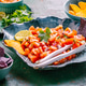 Traditional Mexican tomato salad with lime, onions and nachos with assorted dips Traditional Mexican tomato salad with lime, onions and nachos with assorted dips - PhotoDune Item for Sale