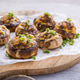 Champignon mushrooms stuffed with cheese, vegetables and fresh herbs, oven baked Champignon mushrooms stuffed with cheese, vegetables and fresh herbs, oven baked - PhotoDune Item for Sale
