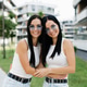 Customer Sisters Smiling Together in City Park Customer Sisters Smiling Together in City Park - PhotoDune Item for Sale