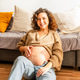 Portrait of Pregnant Latin Woman Sitting on Floor With Hands on Belly in Living Room Portrait of Pregnant Latin Woman Sitting on Floor With Hands on Belly in Living Room - PhotoDune Item for Sale