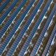 Harvesting solar energy from photovoltaic panels arranged in parallel at renewable energy facility Harvesting solar energy from photovoltaic panels arranged in parallel at renewable energy facility - PhotoDune Item for Sale