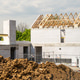 Constructing residential building with wooden roof trusses and concrete blocks onsite Constructing residential building with wooden roof trusses and concrete blocks onsite - PhotoDune Item for Sale