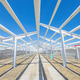 Concrete columns forming open warehouse structure under blue sky Concrete columns forming open warehouse structure under blue sky - PhotoDune Item for Sale