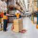 Logistics workers collaborating moving boxes in distribution warehouse Logistics workers collaborating moving boxes in distribution warehouse - PhotoDune Item for Sale