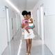 African american mother holding child and using smartphone in hospital African american mother holding child and using smartphone in hospital - PhotoDune Item for Sale
