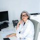 Senior female doctor working in modern office clinic Senior female doctor working in modern office clinic - PhotoDune Item for Sale