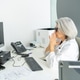 Senior female doctor feeling stressed and overworked at desk Senior female doctor feeling stressed and overworked at desk - PhotoDune Item for Sale