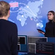 Team collaborating in a SOC monitoring critical cybersecurity events on a world map Team collaborating in a SOC monitoring critical cybersecurity events on a world map - PhotoDune Item for Sale