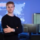 Confident cybersecurity analyst poses in front of data systems with extended monitors Confident cybersecurity analyst poses in front of data systems with extended monitors - PhotoDune Item for Sale