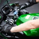 Rider Hands Gripping Green Motorcycle Handlebars Rider Hands Gripping Green Motorcycle Handlebars - PhotoDune Item for Sale