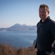 Man Standing Overlooking Scenic Lake Mountains Man Standing Overlooking Scenic Lake Mountains - PhotoDune Item for Sale