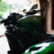 Green motorcycle parked inside residential garage Green motorcycle parked inside residential garage - PhotoDune Item for Sale