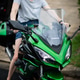 Woman Smiling While Sitting Green Kawasaki Motorcycle Woman Smiling While Sitting Green Kawasaki Motorcycle - PhotoDune Item for Sale