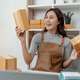 Small business owner packing customer orders, sealing shipping boxes, organizing parcels and managin Small business owner packing customer orders, sealing shipping boxes, organizing parcels and managin - PhotoDune Item for Sale