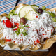 Colorful salad with cheese and vegetables on a wooden plate at a restaurant Colorful salad with cheese and vegetables on a wooden plate at a restaurant - PhotoDune Item for Sale