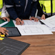 Close-up of architect drafting a floor plan on desk with pencil, ruler and model building, modern of Close-up of architect drafting a floor plan on desk with pencil, ruler and model building, modern of - PhotoDune Item for Sale