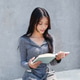 Asian girl reading a book at outdoor cafe Asian girl reading a book at outdoor cafe - PhotoDune Item for Sale