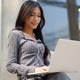 Asian girl typing on laptop at outdoor cafe Asian girl typing on laptop at outdoor cafe - PhotoDune Item for Sale