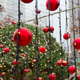 Close view of red Christmas ornaments among hanging fairy lights. Holiday street decoration, winter Close view of red Christmas ornaments among hanging fairy lights. Holiday street decoration, winter - PhotoDune Item for Sale