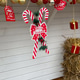 Close-up Festive Christmas stall decorated with hanging ornaments, candy canes and gift boxes. Holid Close-up Festive Christmas stall decorated with hanging ornaments, candy canes and gift boxes. Holid - PhotoDune Item for Sale