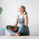 Young woman holding yoga mat on white studio background Young woman holding yoga mat on white studio background - PhotoDune Item for Sale
