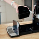 Woman holding coffee machine grounds container during cleaning Woman holding coffee machine grounds container during cleaning - PhotoDune Item for Sale