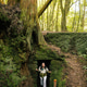 Young woman exploring an ancient lava tunnel during a hike in the azores Young woman exploring an ancient lava tunnel during a hike in the azores - PhotoDune Item for Sale