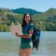 Young woman working remotely on laptop with backpack by a lake Young woman working remotely on laptop with backpack by a lake - PhotoDune Item for Sale