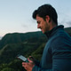 Young man flying drone over sao miguel landscape at dusk Young man flying drone over sao miguel landscape at dusk - PhotoDune Item for Sale
