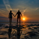Couple hand in hand towards the sea in a dawn late summer Couple hand in hand towards the sea in a dawn late summer - PhotoDune Item for Sale