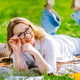 Woman with glasses on green grass, summer lifestyle portrait. Beautiful adult person at remote work Woman with glasses on green grass, summer lifestyle portrait. Beautiful adult person at remote work - PhotoDune Item for Sale