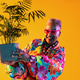 Senior woman holding potted plant smiling cheerfully Senior woman holding potted plant smiling cheerfully - PhotoDune Item for Sale