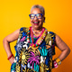 Smiling senior black woman posing with vibrant style Smiling senior black woman posing with vibrant style - PhotoDune Item for Sale