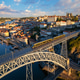 Sunrise drone view of tram on Dom Luis I Bridge with hillside streets Sunrise drone view of tram on Dom Luis I Bridge with hillside streets - PhotoDune Item for Sale