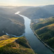 Sunlit douro river over vineyard hills in Portugal at sunrise Sunlit douro river over vineyard hills in Portugal at sunrise - PhotoDune Item for Sale