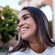 Young latin woman smiling outdoors in urban setting Young latin woman smiling outdoors in urban setting - PhotoDune Item for Sale