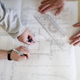 Young Architects Are Bent Over a Drawing, Discussing a Project Young Architects Are Bent Over a Drawing, Discussing a Project - PhotoDune Item for Sale