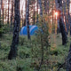 A Blue Tourist Tent Stands in the Forest in the Rays of the Setting Sun A Blue Tourist Tent Stands in the Forest in the Rays of the Setting Sun - PhotoDune Item for Sale