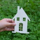 House Model in Children's Hands on the Background of Clover, House Model in Children's Hands on the Background of Clover, - PhotoDune Item for Sale