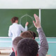 A view from behind a student answering a question during a university lecture. A view from behind a student answering a question during a university lecture. - PhotoDune Item for Sale