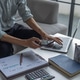 Businessman calculating expenses and reviewing financial statistics using smartphone and laptop. Businessman calculating expenses and reviewing financial statistics using smartphone and laptop. - PhotoDune Item for Sale