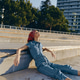 Relaxed Woman in Denim Jumpsuit and Red Headscarf Lounging Outdoors on Concrete Steps Under Bright Relaxed Woman in Denim Jumpsuit and Red Headscarf Lounging Outdoors on Concrete Steps Under Bright - PhotoDune Item for Sale