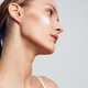 Young woman with smooth skin applies cream on cheek looking sideways showing natural beauty and Young woman with smooth skin applies cream on cheek looking sideways showing natural beauty and - PhotoDune Item for Sale