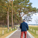 Senior man on seaside path. Vertical outdoor walking scene. Senior man on seaside path. Vertical outdoor walking scene. - PhotoDune Item for Sale